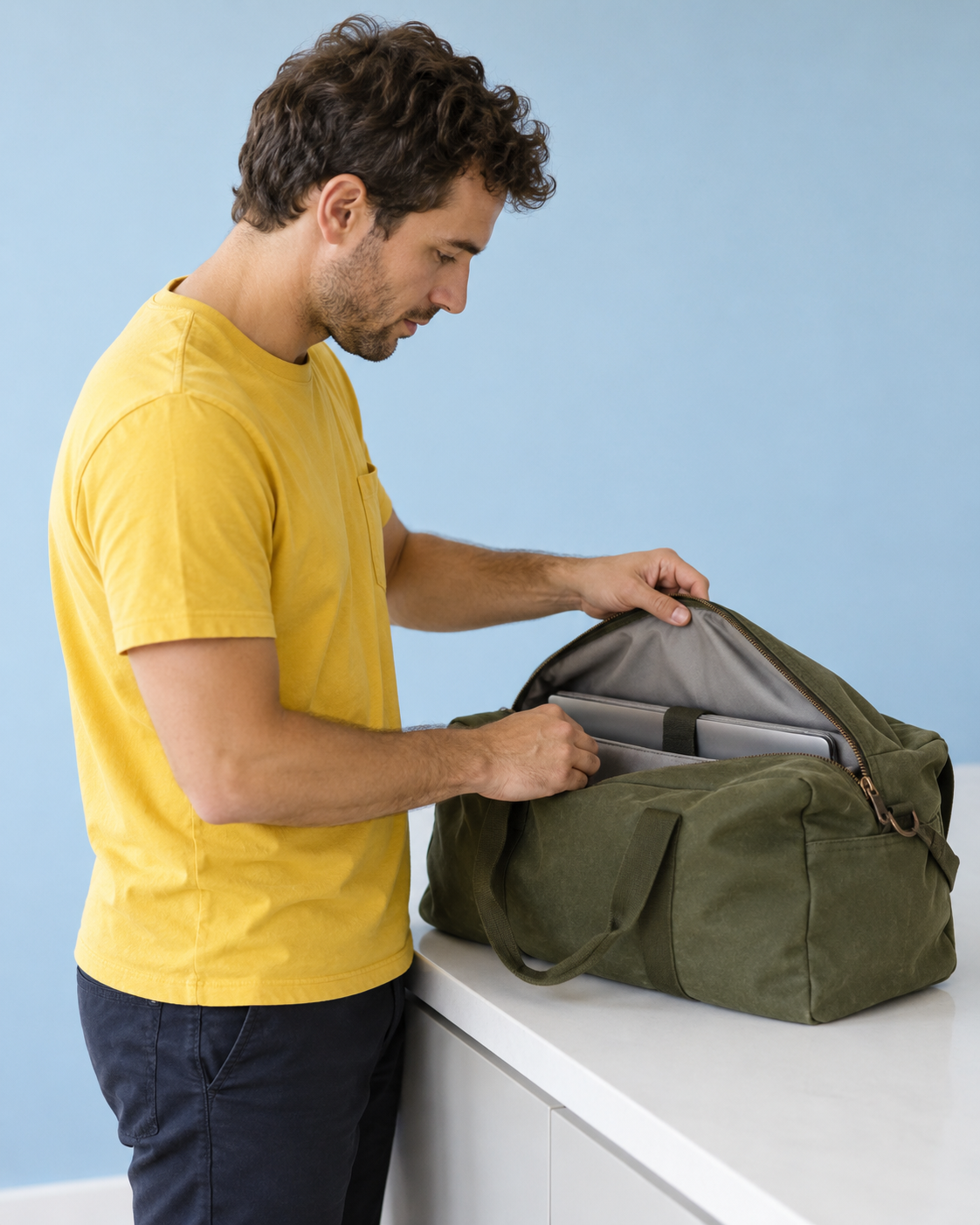 A customer checking the compartment of a green weekender